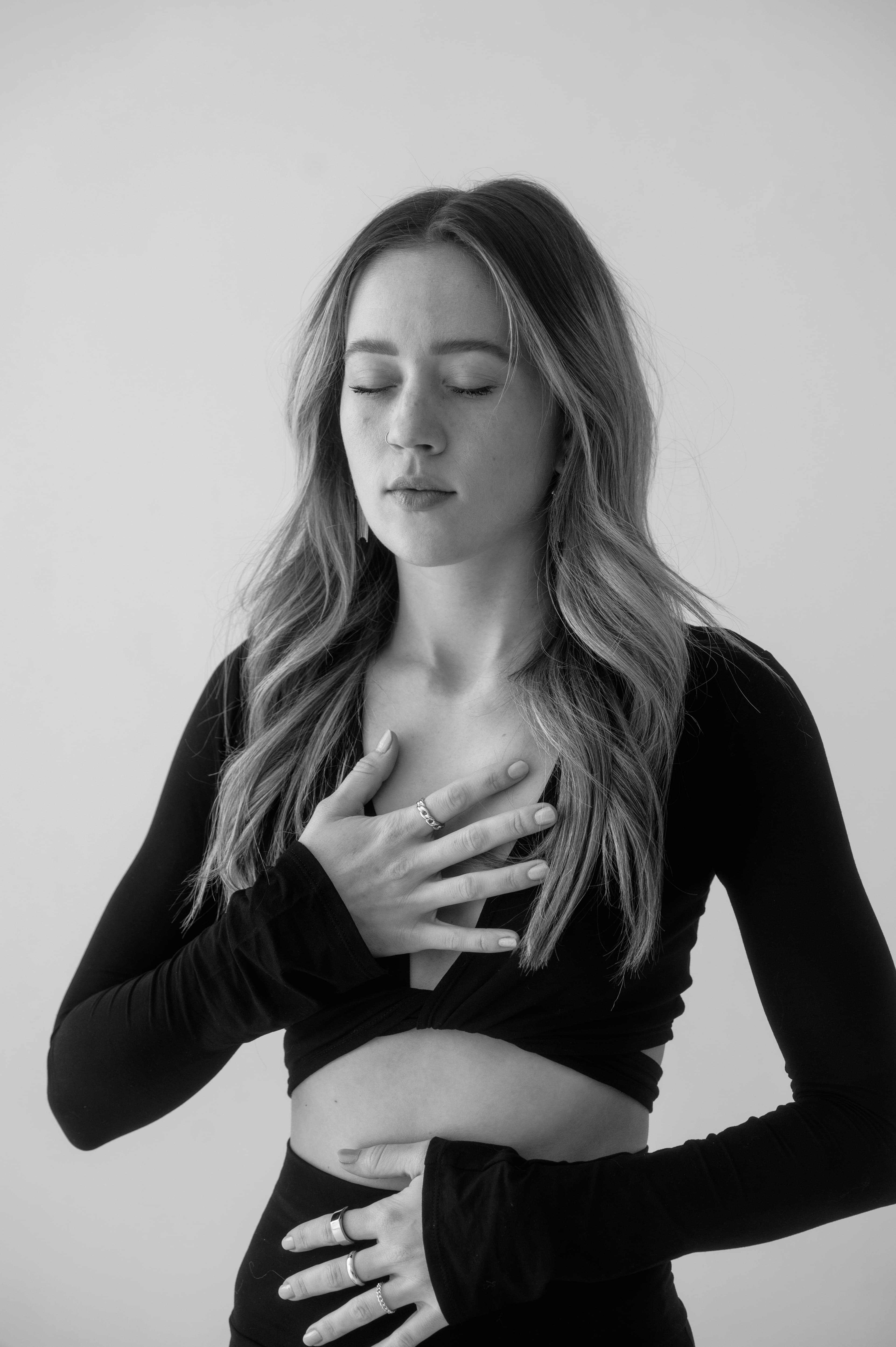 Lindsay with hands placed on heart and stomach